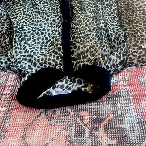 Sheer, long sleeve blouse with cut out shoulders. 100% polyester. Hand wash cold